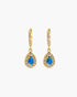 Gold earrings with blue gemstones on a white background